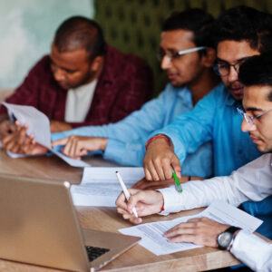 Group of four south asian men's posed at business meeting in caf